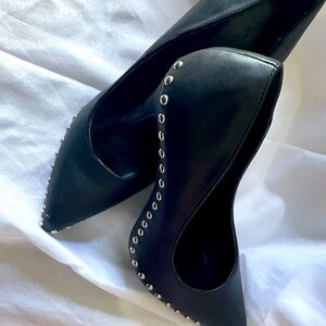 Black spiked pumps.